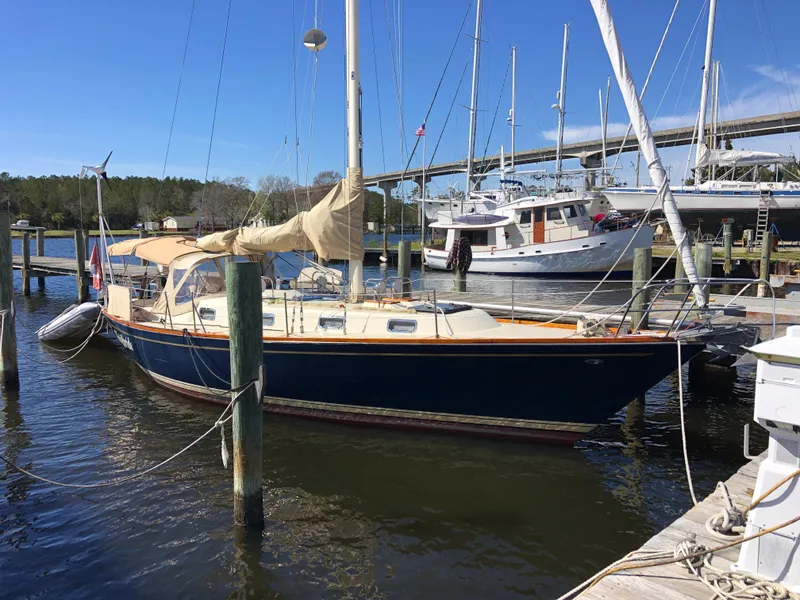 The Image of 1979 Tartan 37C sailboat docked at a marina under clear blue skies. - 0
