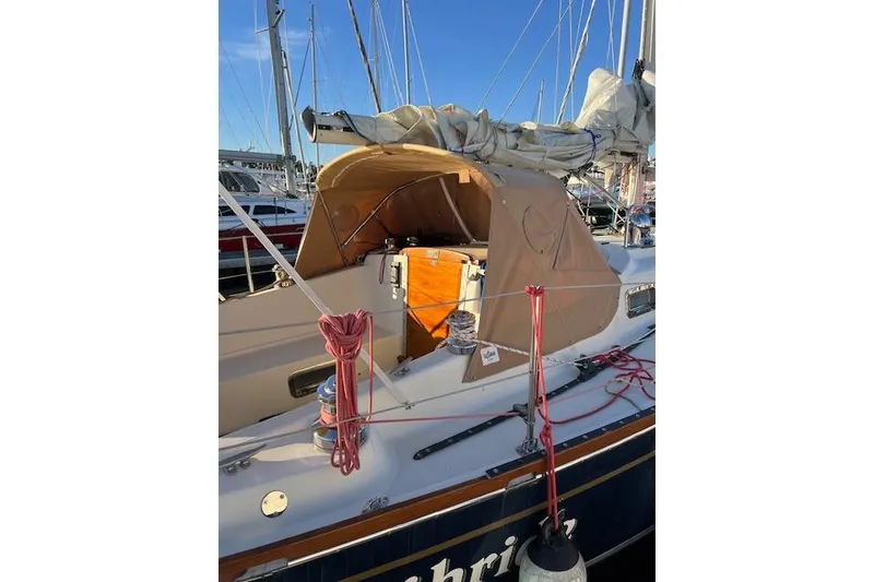 Slide: The Image of 1979 Tartan 37C sailboat with tan canopy, docked in a marina. - 11