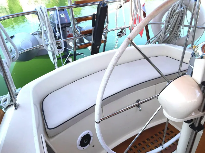 Slide: The Image of 1979 Tartan 37C sailboat cockpit with steering wheel and seating, docked by the water. - 13
