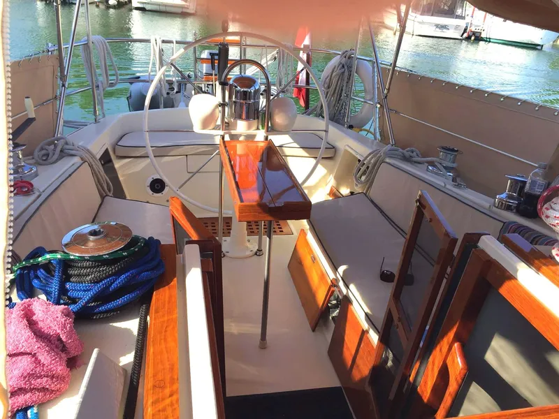 Slide: The Image of 1979 Tartan 37C sailboat cockpit with wooden accents and nautical equipment. - 15