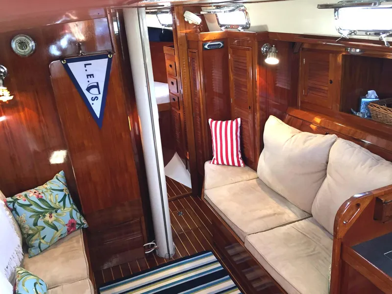 Slide: The Image of 1979 Tartan 37C yacht interior with cozy seating, wooden finish, and nautical decor. - 18