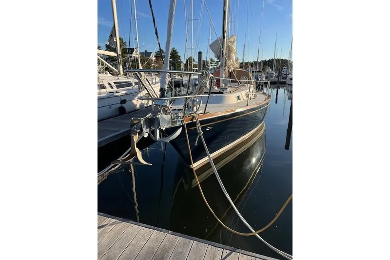 Slide: The Image of 1979 Tartan 37C sailboat docked in marina, reflecting on calm water. - 2