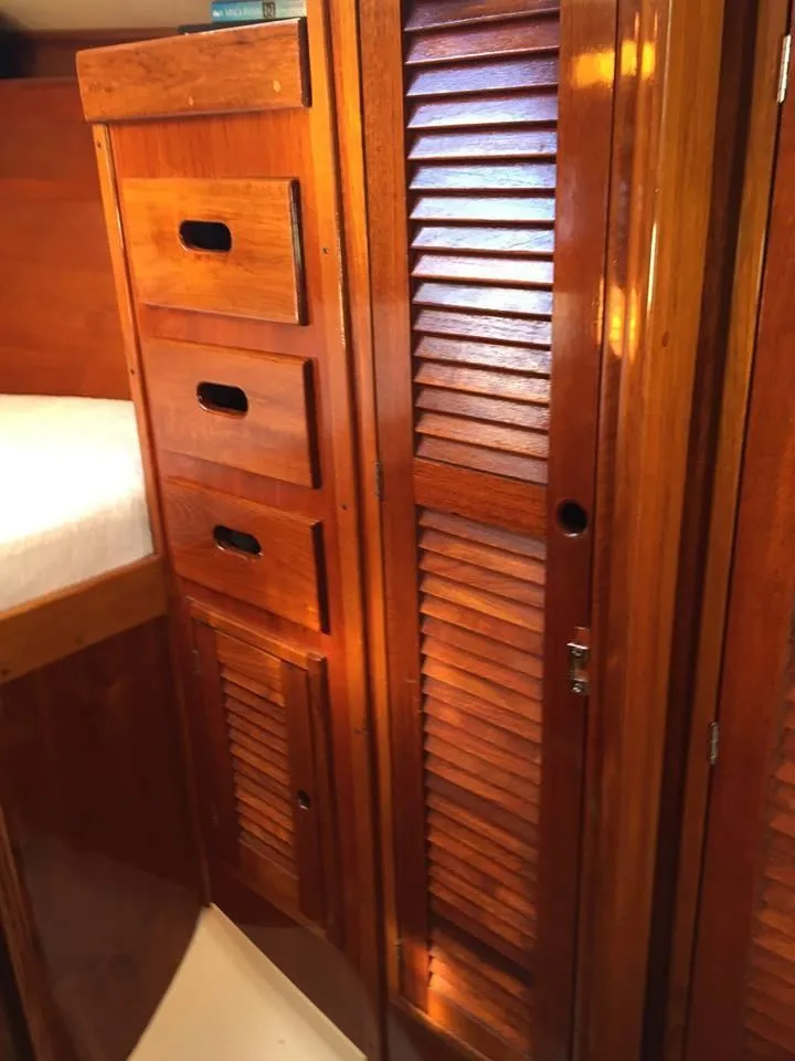 Slide: The Image of 1979 Tartan 37C interior with wooden drawers and louvered cabinet door. - 25