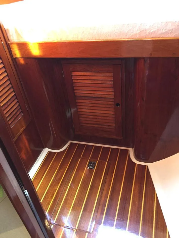 Slide: The Image of Interior of 1979 Tartan 37C sailboat with polished wood finish and louvered door. - 27