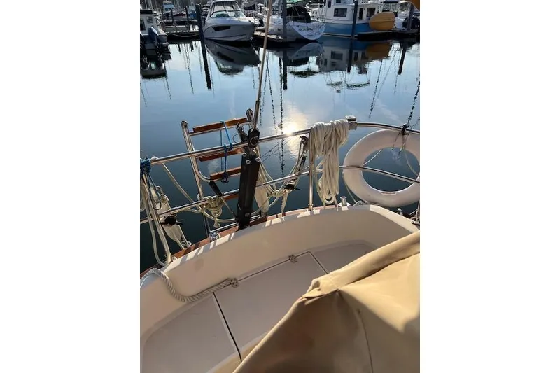 Slide: The Image of 1979 Tartan 37C sailboat docked in a marina, with calm water reflections. - 32
