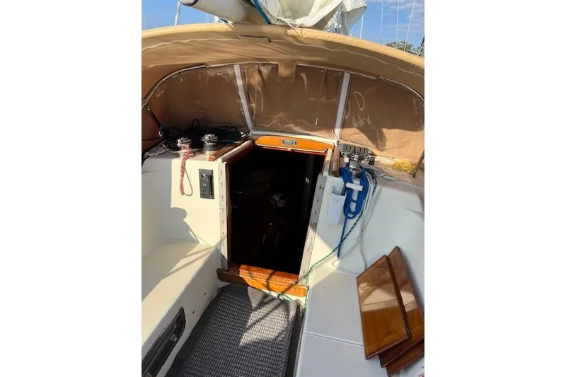 Slide: The Image of 1979 Tartan 37C sailboat cockpit with open cabin door and nautical equipment. - 35