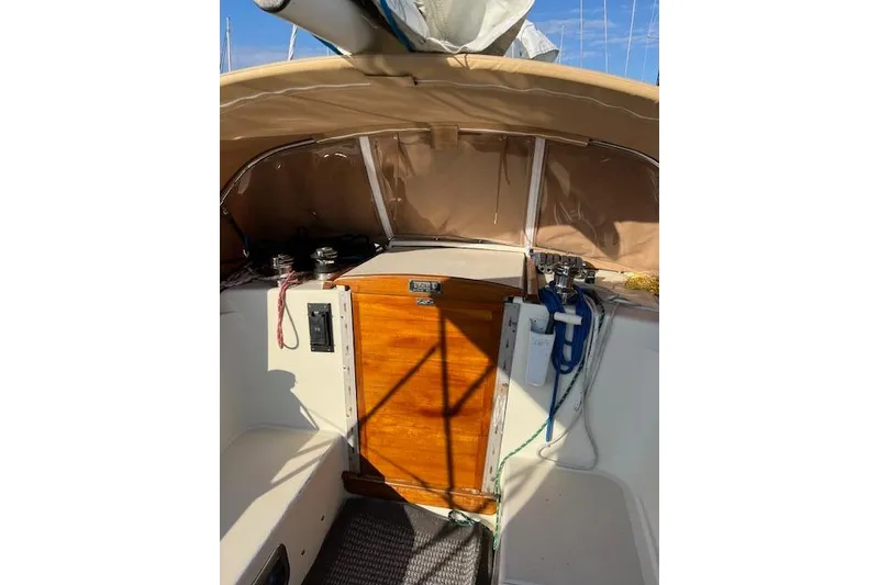 Slide: The Image of 1979 Tartan 37C sailboat cockpit with wooden hatch and beige canopy. - 36
