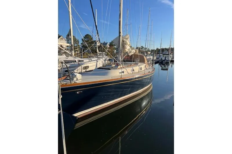 Slide: The Image of 1979 Tartan 37C sailboat docked in a serene marina setting. - 4