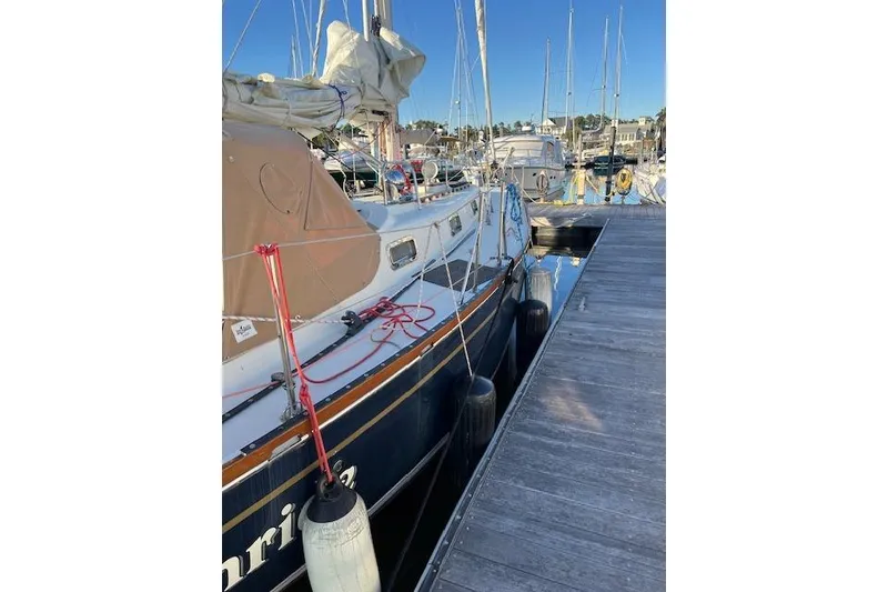 Slide: The Image of 1979 Tartan 37C sailboat docked at marina, featuring classic design and rigging. - 46