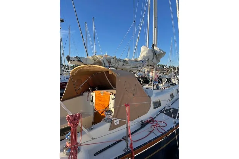 Slide: The Image of 1979 Tartan 37C sailboat docked, featuring tan canopy and neatly coiled ropes. - 47