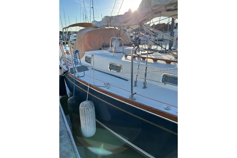 Slide: The Image of 1979 Tartan 37C sailboat docked at marina, sunlit deck and rigging visible. - 49