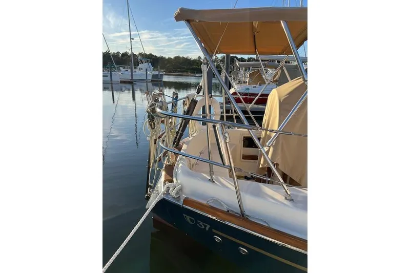 Slide: The Image of 1979 Tartan 37C sailboat docked in a serene marina setting. - 53