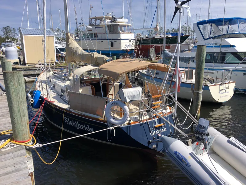 Slide: The Image of 1979 Tartan 37C sailboat docked at marina, surrounded by other boats. - 7