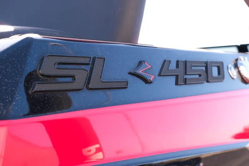 Slide: The Image of 2022 Supra SL 450 badge on a sleek black and red surface. - 10