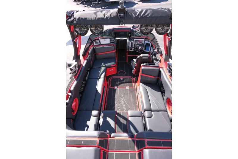 Slide: The Image of 2022 Supra SL boat interior with sleek black and red seating and advanced dashboard. - 13
