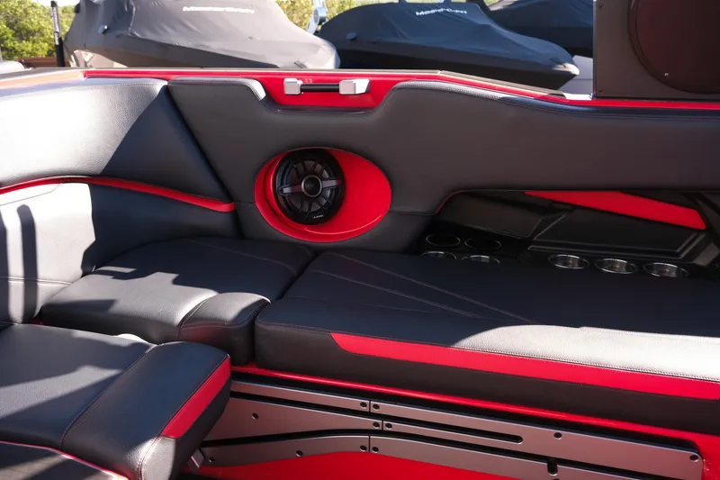 Slide: The Image of 2022 Supra SL boat interior with black and red seating, speaker, and cup holders. - 17