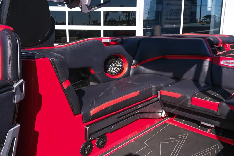 Slide: The Image of 2022 Supra SL boat interior with red and black seating, featuring built-in speakers. - 19