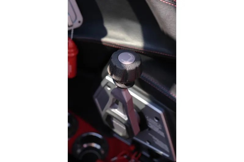 Slide: The Image of 2022 Supra SL gear shift lever with black and red interior accents. - 21