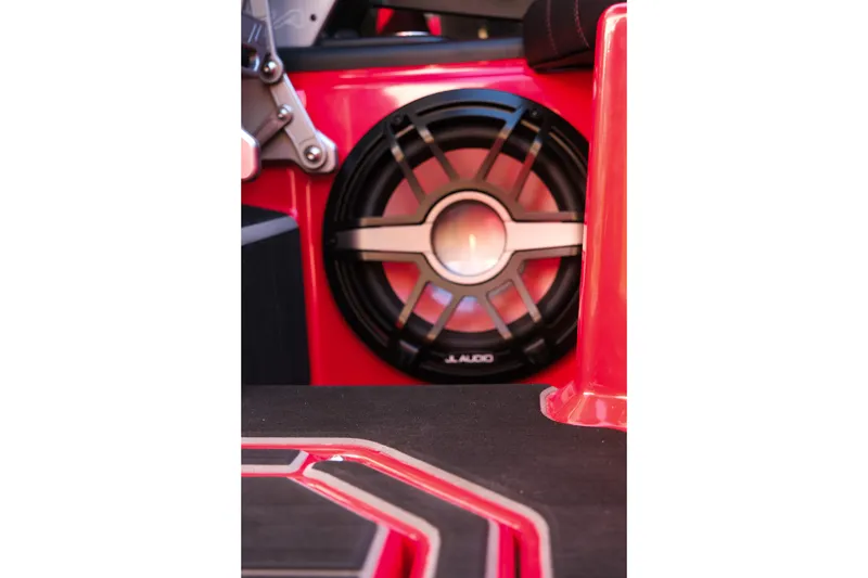 Slide: The Image of 2022 Supra SL audio system with JL Audio speaker in red interior. - 23
