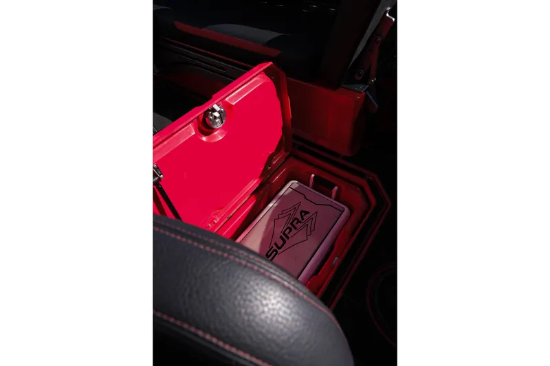 Slide: The Image of 2022 Supra SL interior with open red storage compartment. - 27