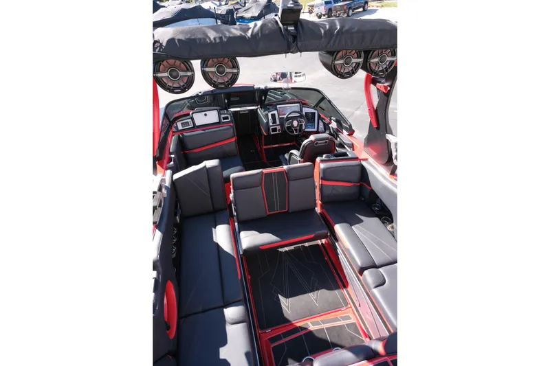 Slide: The Image of 2022 Supra SL boat interior with black and red seating, advanced dashboard, and premium sound system. - 29