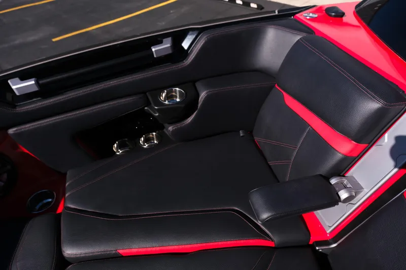 Slide: The Image of 2022 Supra SL interior with black and red leather seats, featuring cup holders and armrest. - 33