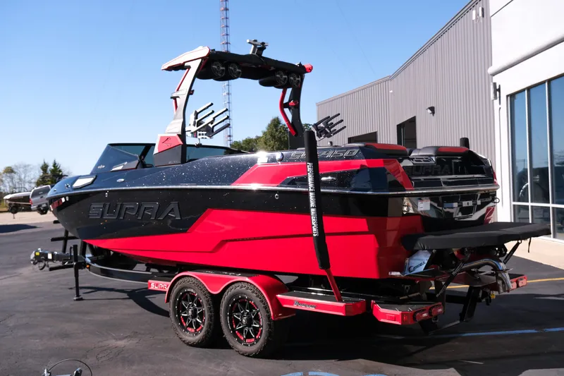 Slide: The Image of 2022 Supra SL boat in red and black, parked outside a building. - 4