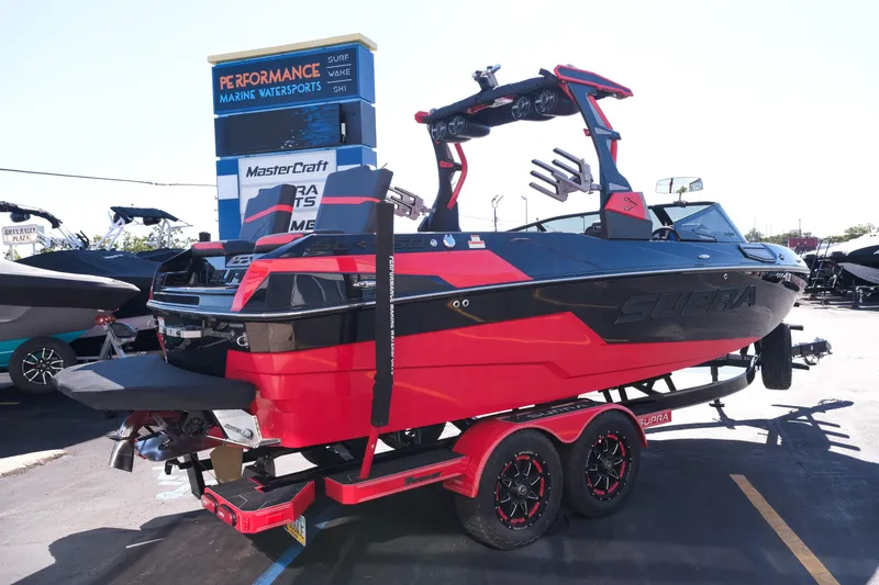 Slide: The Image of 2022 Supra SL boat in red and black at a marine dealership. - 9