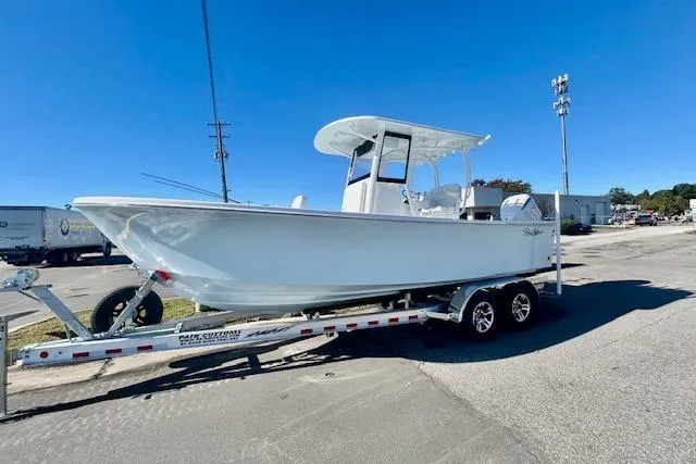 The Image of 2026 Pair Customs 24 Center Console DV Offshore boat on trailer, parked outdoors. - 0