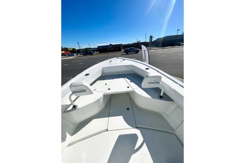 Slide: The Image of 2026 Pair Customs 24 Center Console DV Offshore boat, white interior, parked outdoors. - 10