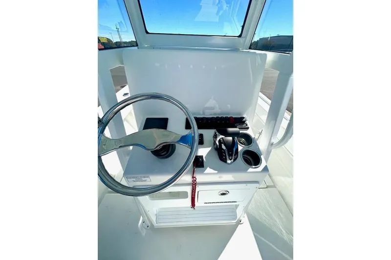 Slide: The Image of 2026 Pair Customs 24 Center Console DV Offshore helm with steering wheel and controls. - 13