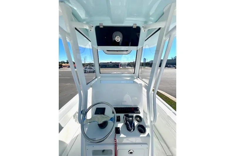 Slide: The Image of 2026 Pair Customs 24 Center Console DV Offshore boat interior with steering wheel and controls. - 5
