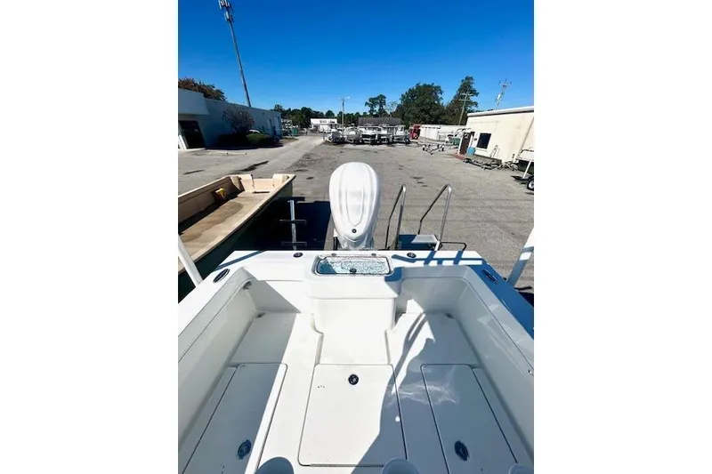 Slide: The Image of 2026 Pair Customs 24 Center Console DV Offshore boat, rear view in a marina setting. - 7