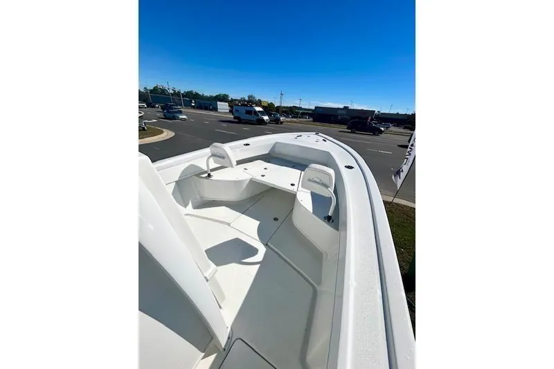 Slide: The Image of 2026 Pair Customs 24 Center Console DV Offshore boat, sleek design, parked outdoors. - 9