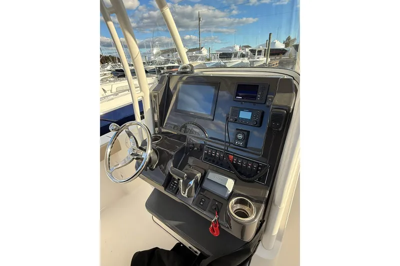 Slide: The Image of 2021 Pursuit C 238 Center Console boat docked with outboard motor. - 10