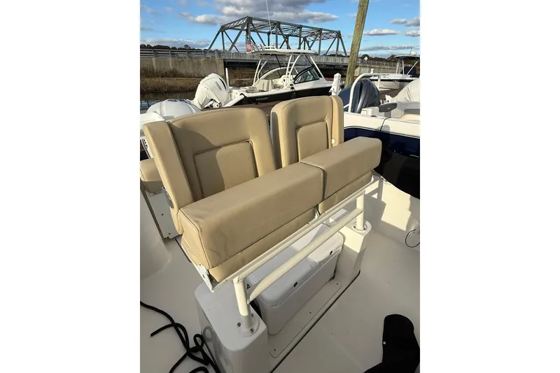 Slide: The Image of 2021 Pursuit C 238 Center Console boat dashboard with steering wheel and navigation equipment. - 13