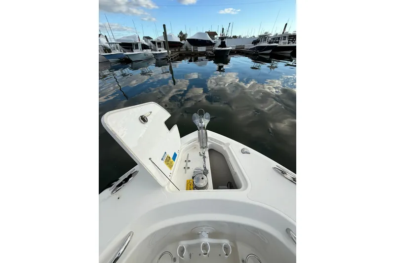 Slide: The Image of 2021 Pursuit C 238 Center Console interior storage compartment with control panel and equipment. - 19