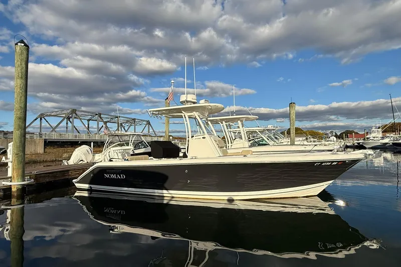 Slide: The Image of 2021 Pursuit C 238 Center Console boat with Yamaha engine on water. - 2