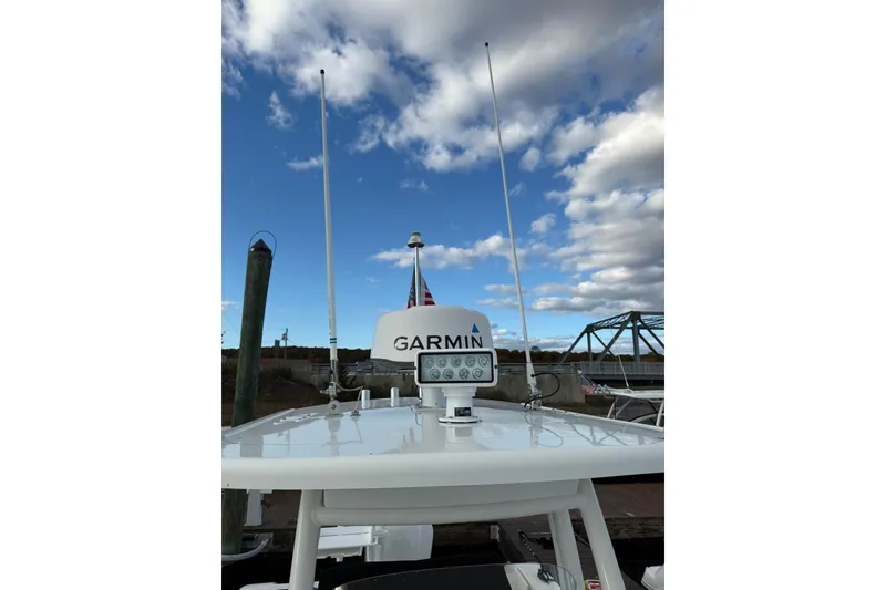 Slide: The Image of 2021 Pursuit C 238 Center Console boat seat with beige upholstery and stainless steel handle. - 20