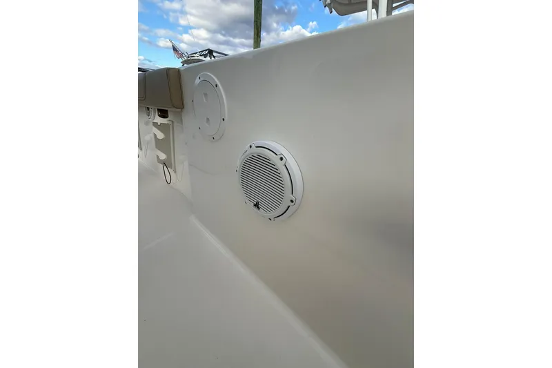 Slide: The Image of 2021 Pursuit C 238 Center Console boat docked in a marina, open anchor compartment. - 22