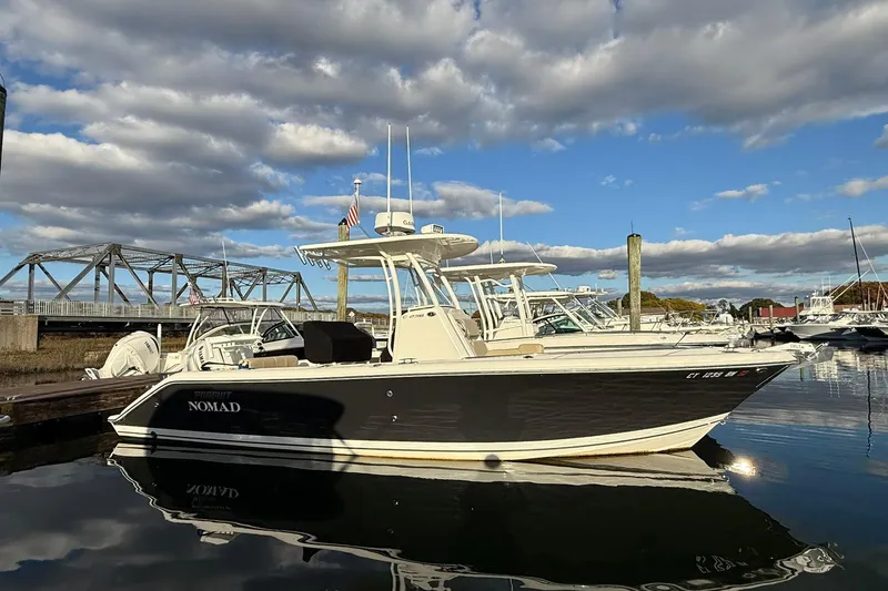 Slide: The Image of 2021 Pursuit C 238 Center Console boat on water, featuring Yamaha engine. - 3