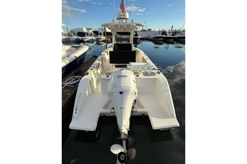 Slide: The Image of 2021 Pursuit C 238 Center Console boat docked at marina under blue sky. - 4