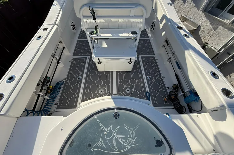 Slide: The Image of 2014 Sea Fox 256 Commander boat interior with seating and fishing rod holders. - 10