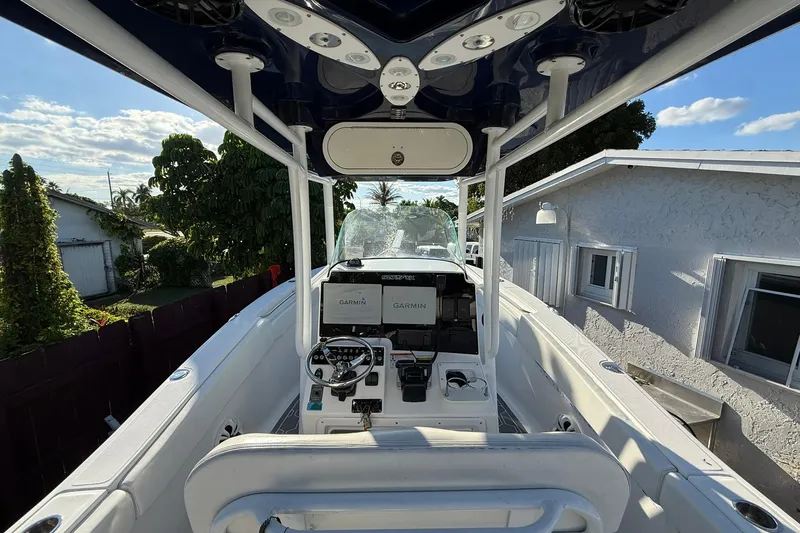 Slide: The Image of 2014 Sea Fox 256 Commander boat interior with Garmin navigation system, parked near a house. - 11