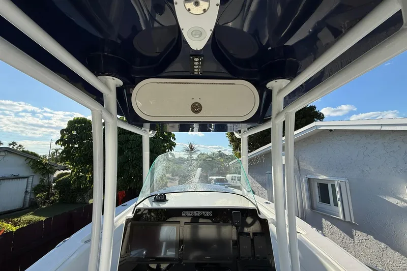 Slide: The Image of 2014 Sea Fox 256 Commander boat interior with T-top and console view. - 13