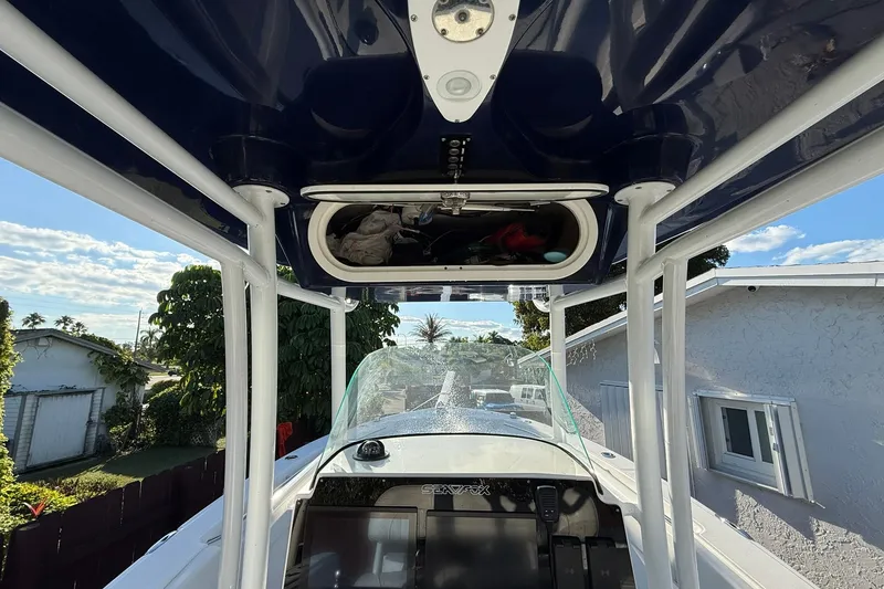 Slide: The Image of 2014 Sea Fox 256 Commander boat interior with T-top and console view. - 14