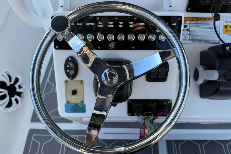 Slide: The Image of Steering wheel and controls of a 2014 Sea Fox 256 Commander boat. - 15