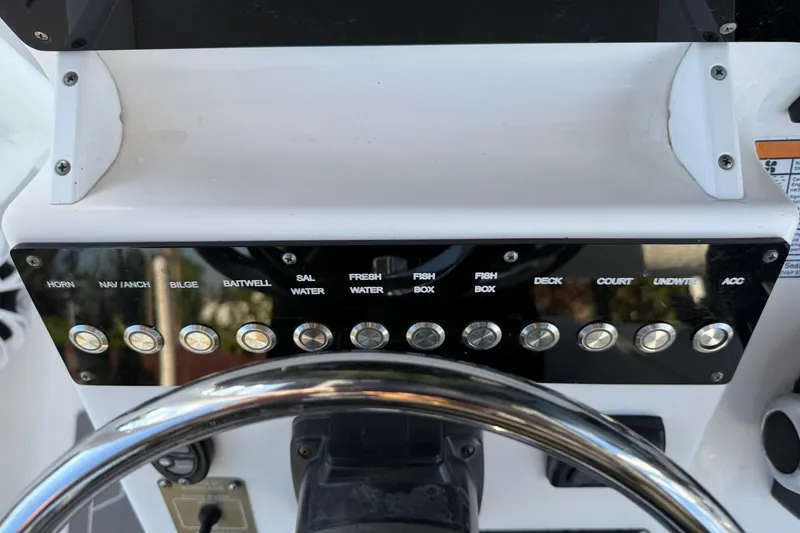 Slide: The Image of Control panel of a 2014 Sea Fox 256 Commander boat with labeled switches. - 19