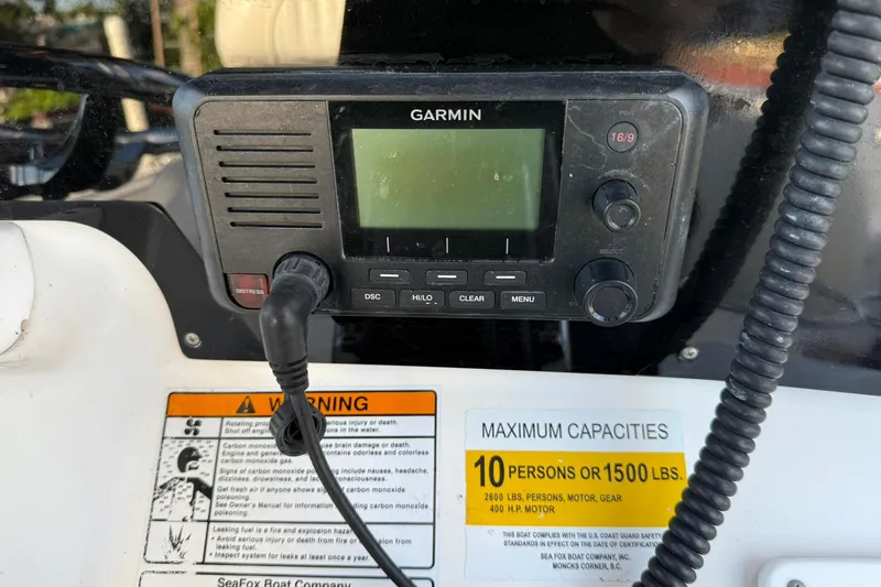 Slide: The Image of Garmin marine radio on 2014 Sea Fox 256 Commander, capacity warning label visible. - 24