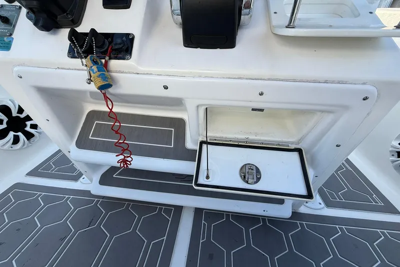 Slide: The Image of 2014 Sea Fox 256 Commander boat console with storage compartment and safety lanyard. - 29
